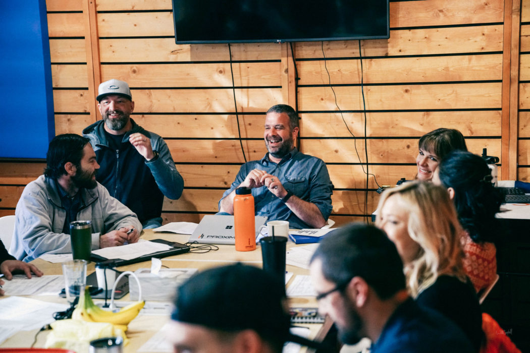 The Proximity team meeting at a table