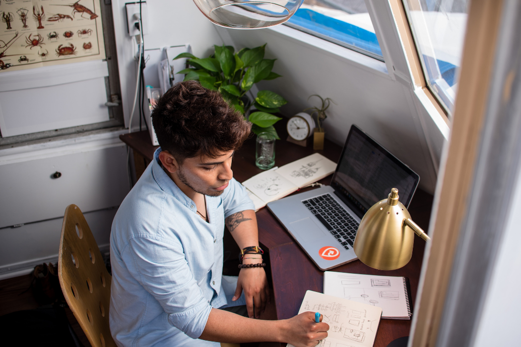 Person working at their desk in front of a window