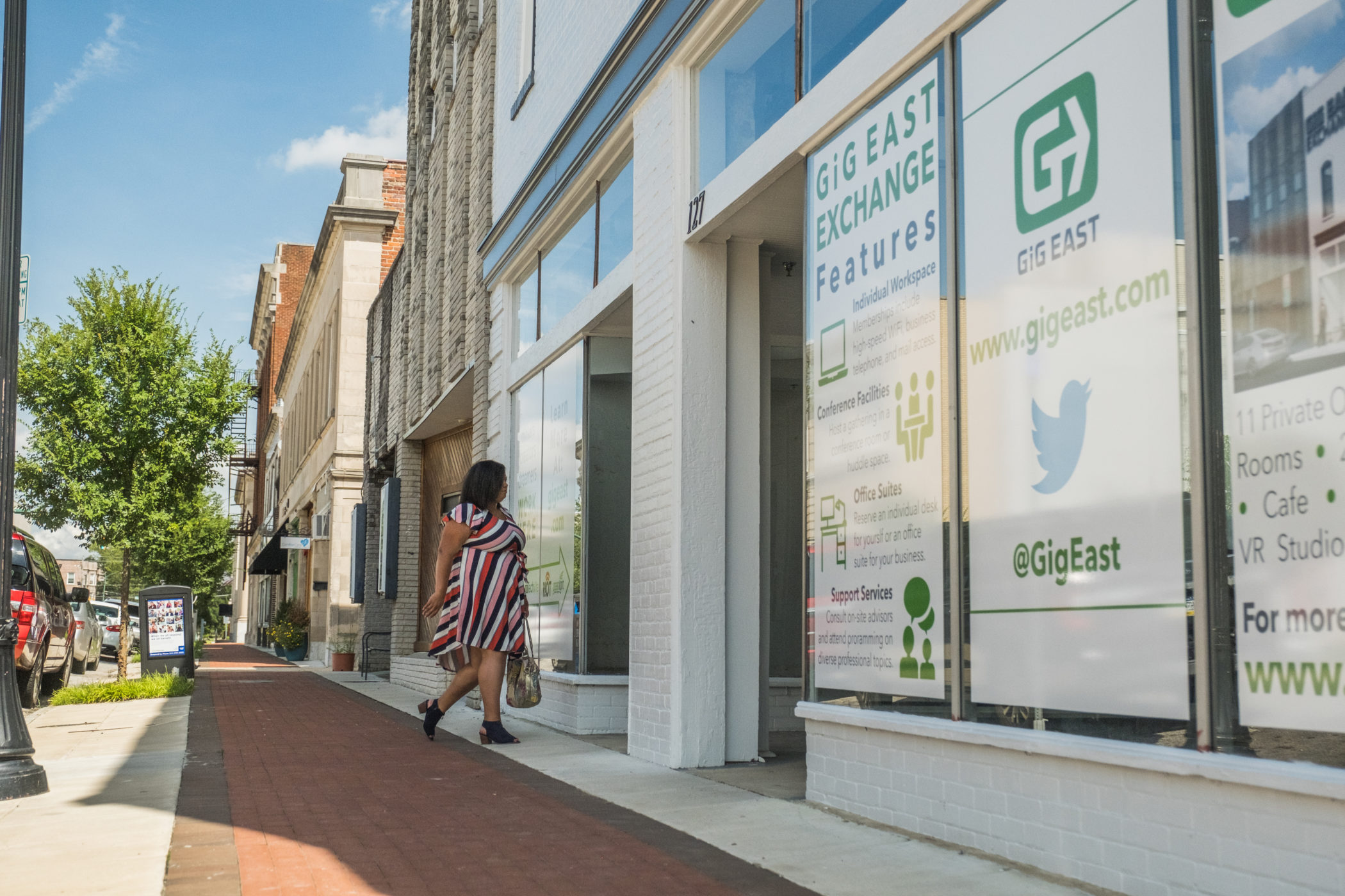 Woman on the street walking into a building