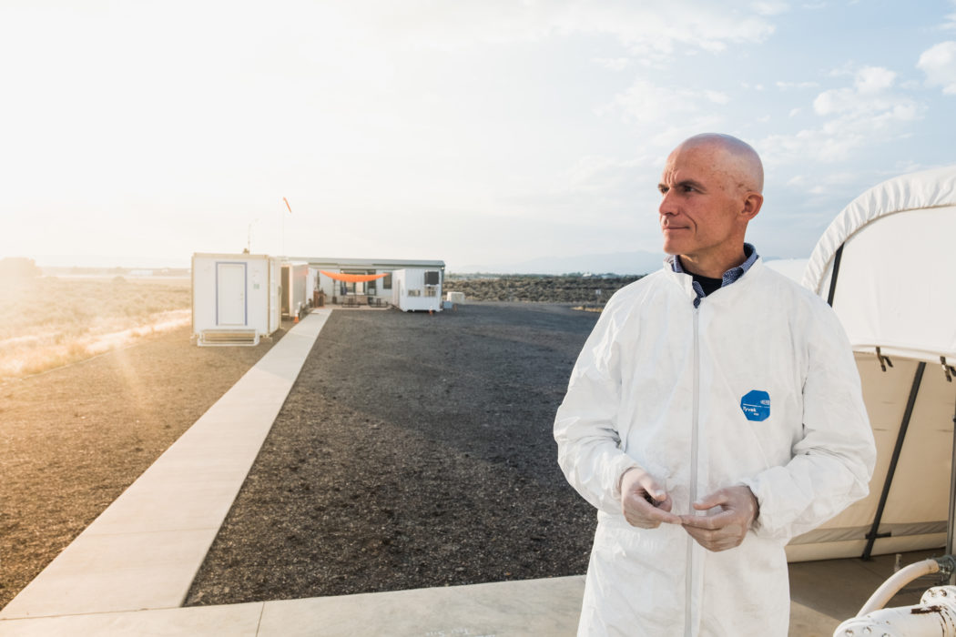 Man standing on a tarmac with the sun shining brightly