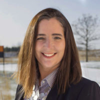 Lisa Groeneveld headshot in front of a scenic background.