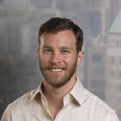 Zack Nolan headshot in front of an artistic background.