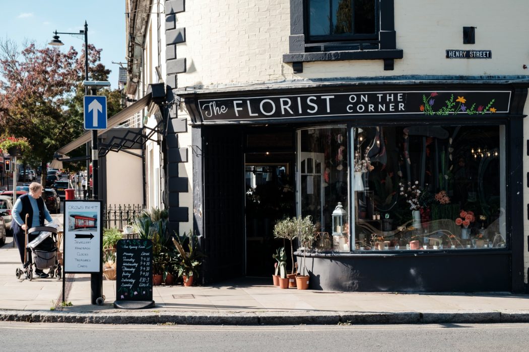 A florist shop on an empty sidewalk.