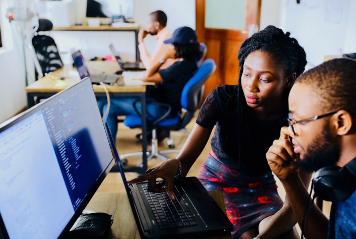 People working together in front of a computer in an office