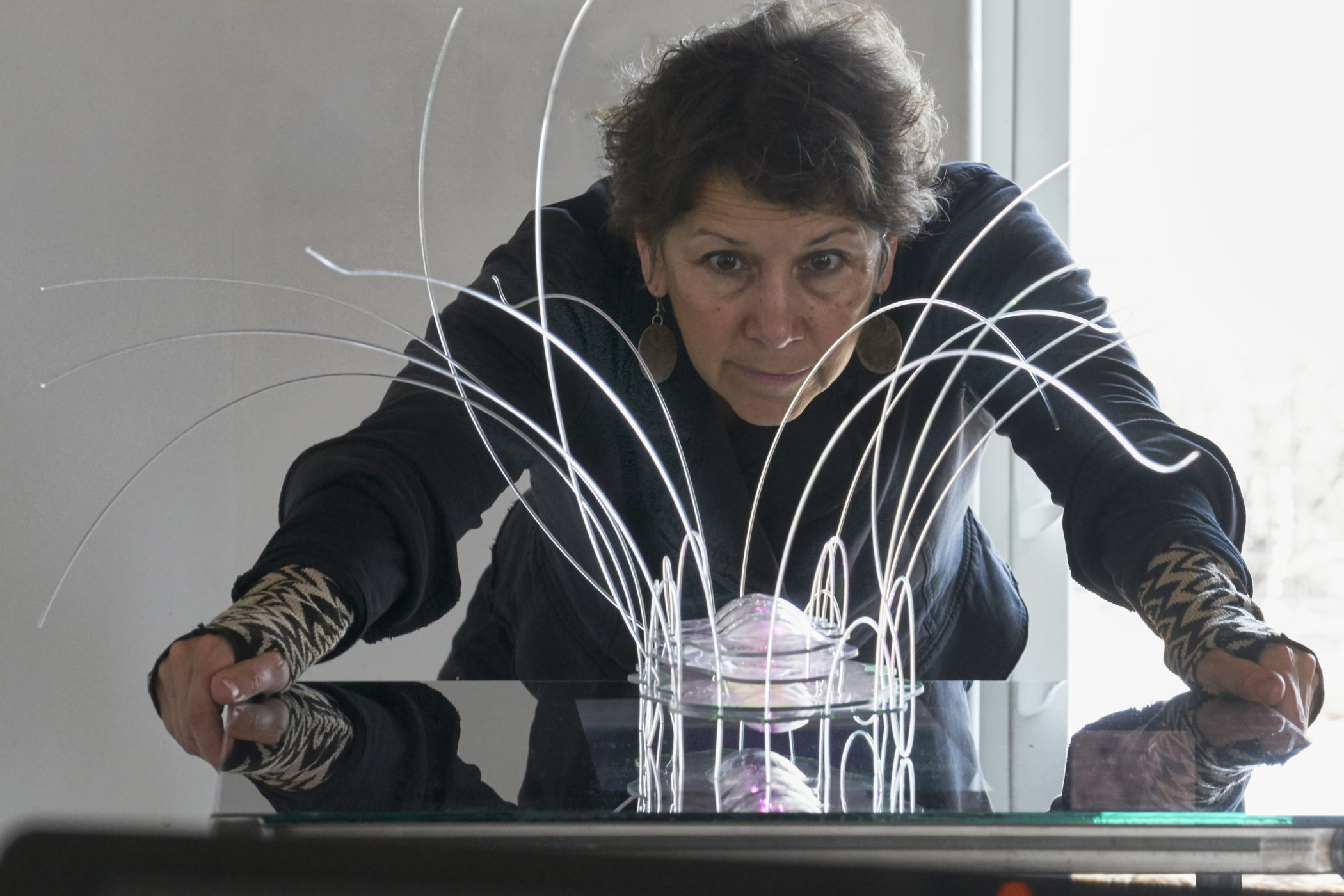 Agnes Chavez examines an art project