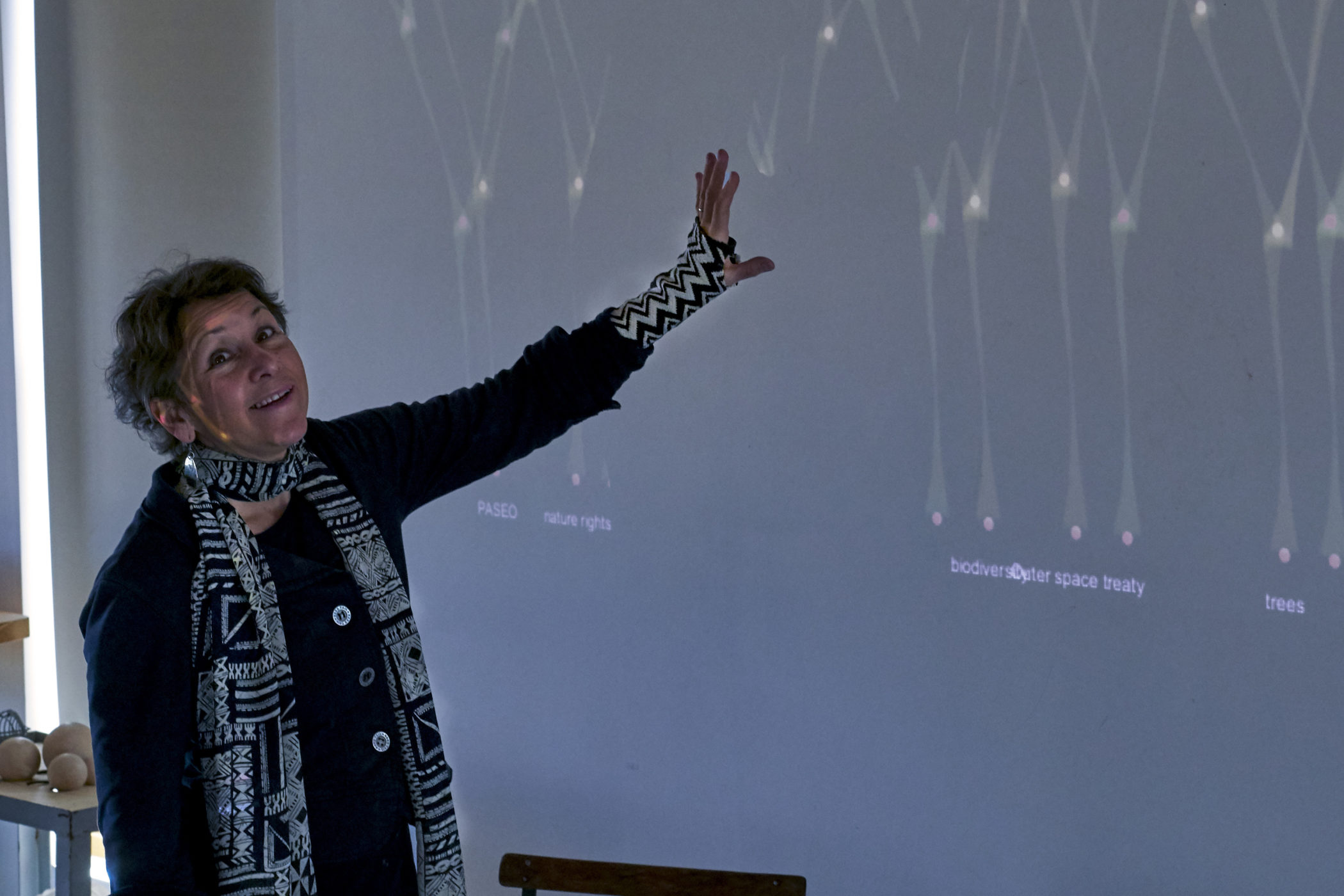 Agnes Chavez gestures toward projection art