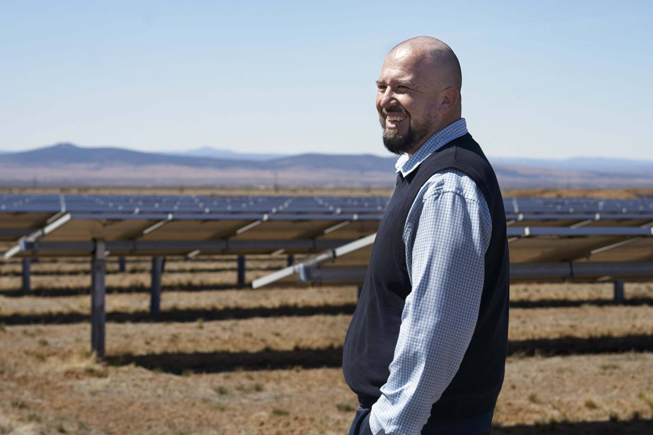 Daniel Trujillo near a solar array he manages in Taos