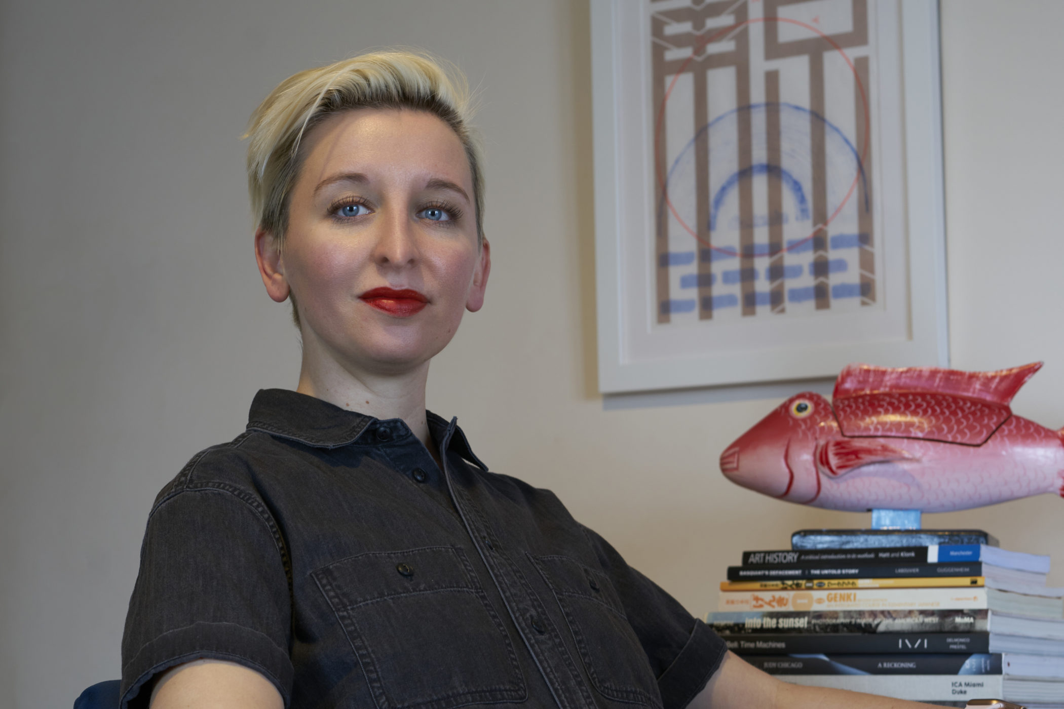Lili Rusing poses for a photo at her desk