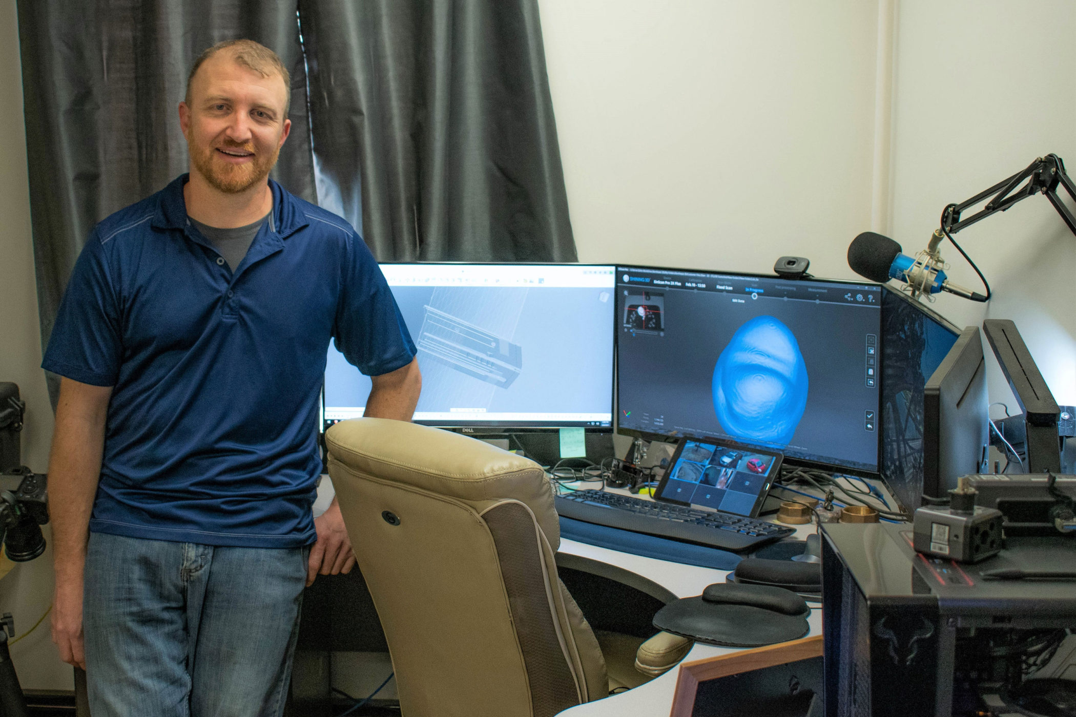 Jason Gaboury stands next to his office desk