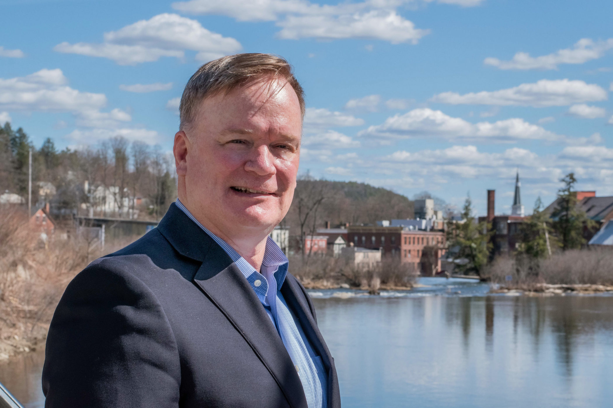 Rick Johnson stands near a river in Springfield