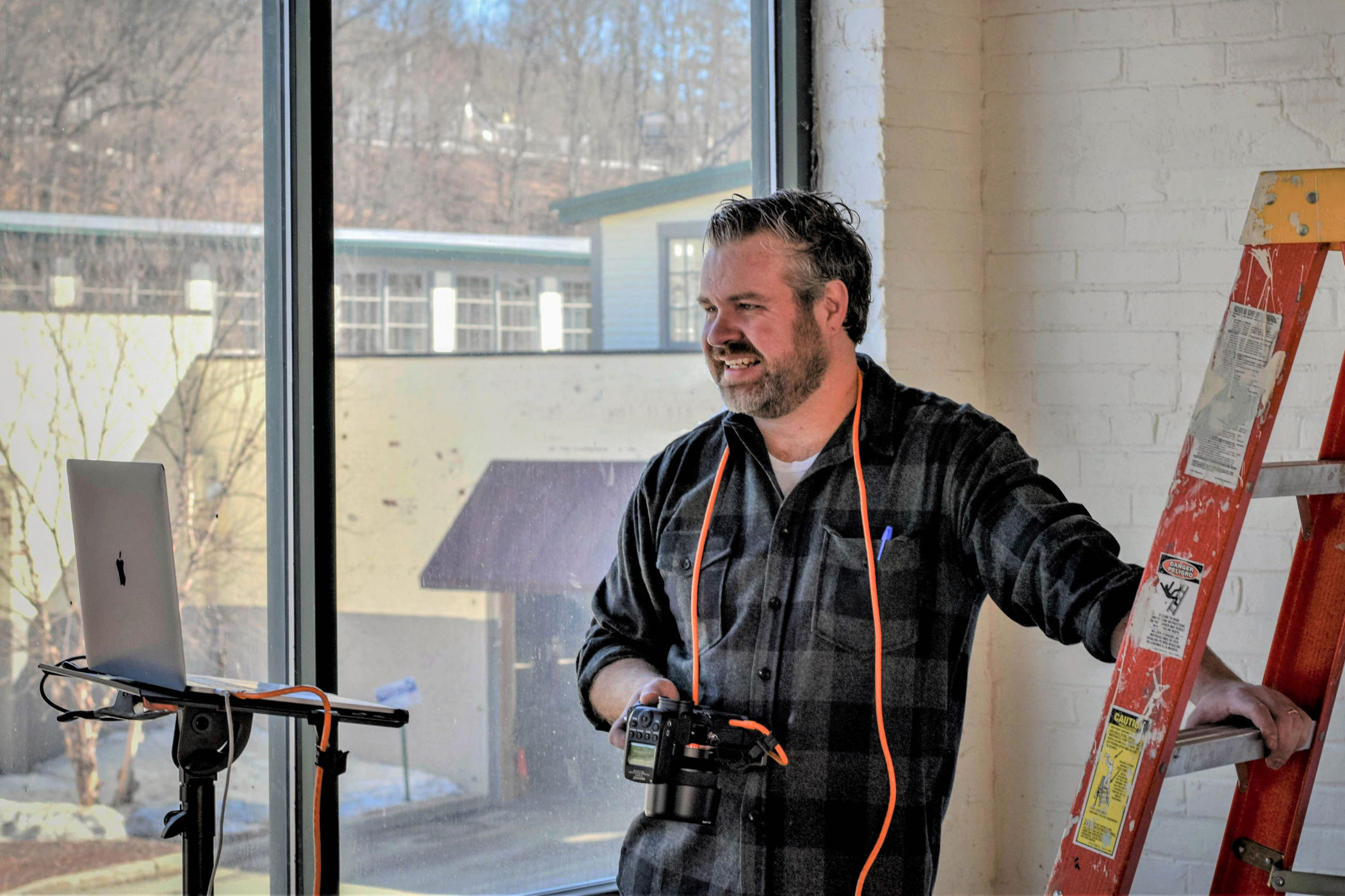 Casimir Krupinsky holds his camera in his studio