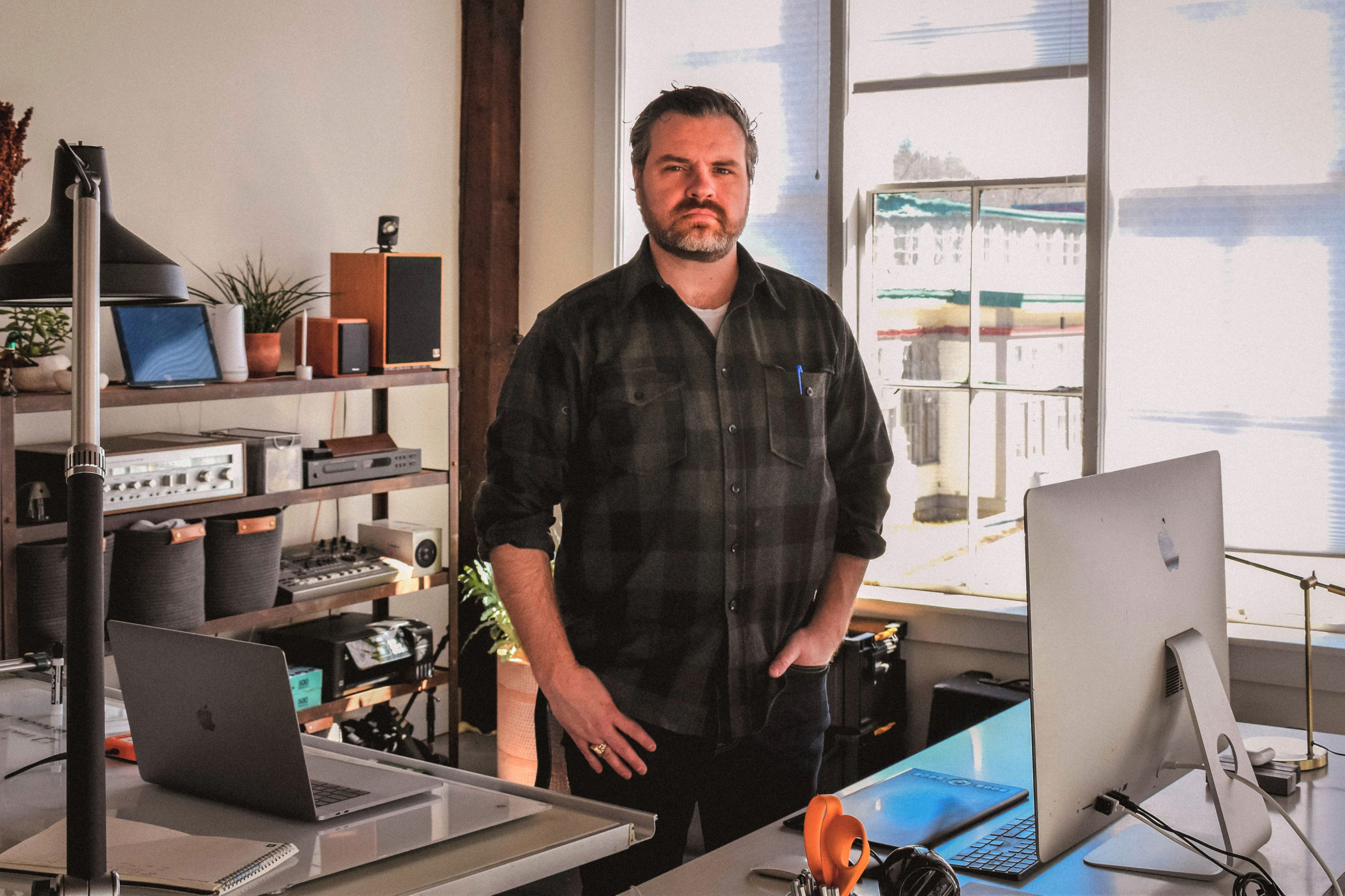 Casimir Krupinsky stands behind his desk
