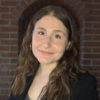 Rose Vieland headshot in front of a brick wall