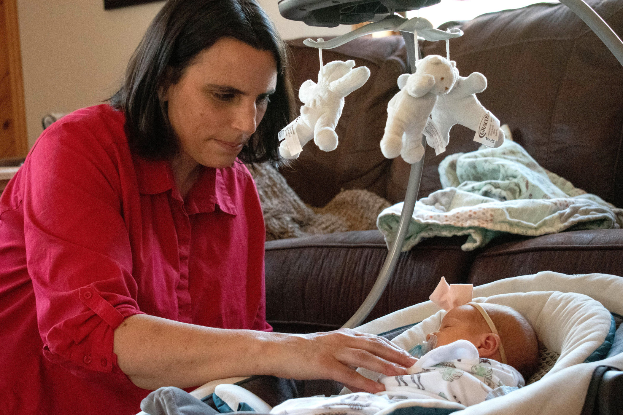 Cara Tyrrell tucking in an infant