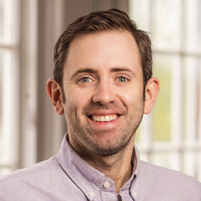 Austin Danforth headshot in front of a window