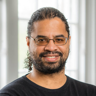 John Hall headshot in front of a window