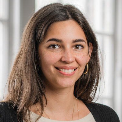 May Erouart headshot in front of a window