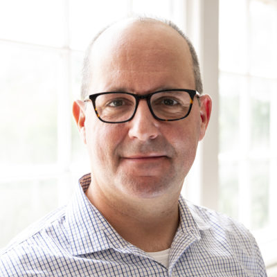 Mike Tavilla headshot in front of a bright window