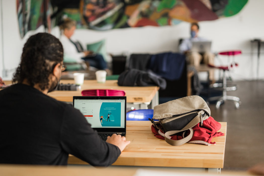 man working on his laptop in an office space