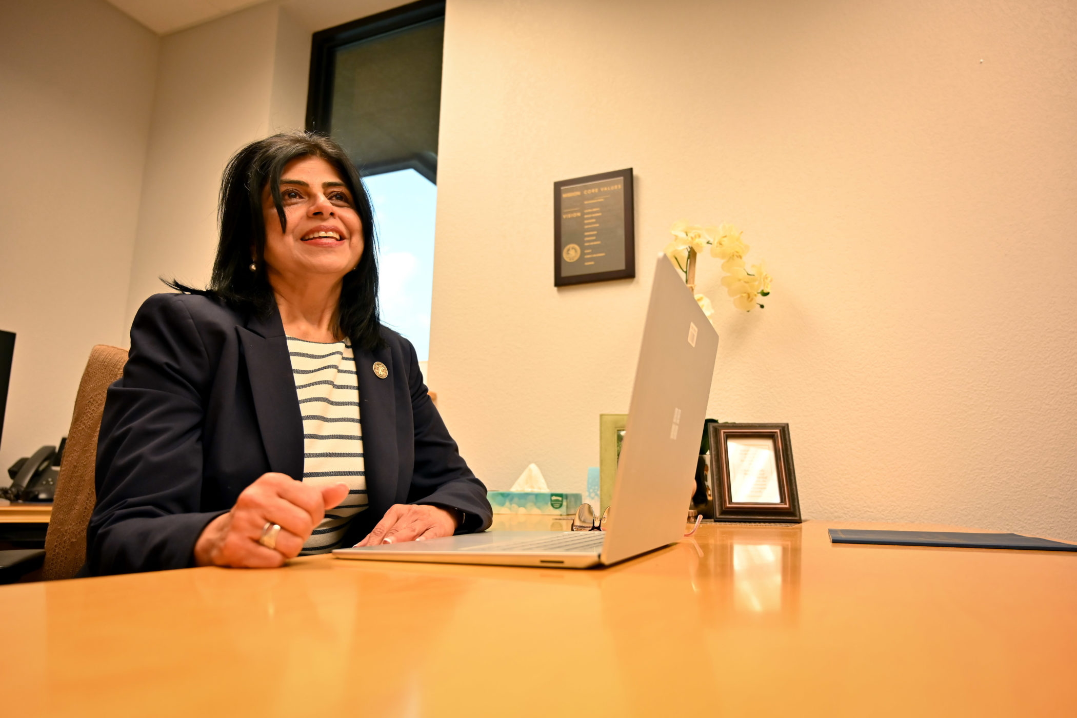 Hursh Juneja sits at her desk