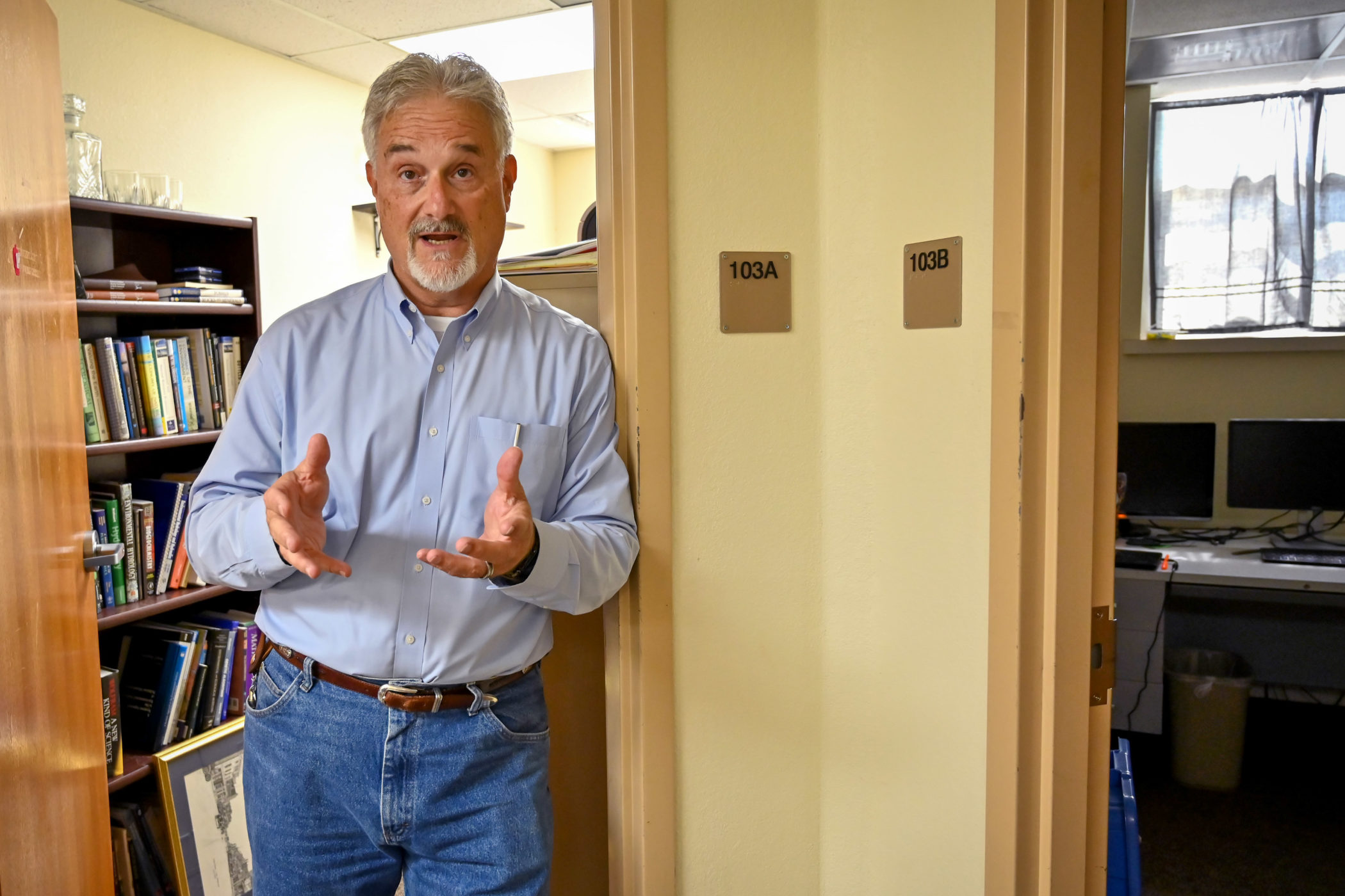 Guy Sewell talks in the doorway to his office at ECU