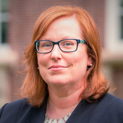Stephanie Tomlin headshot in front of a brick building