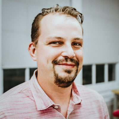 Daniel Parkins headshot in front of a window
