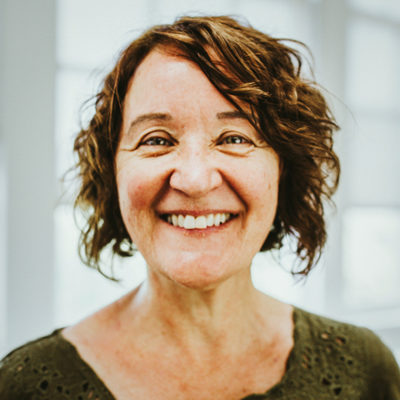 Marie Brazis headshot in front of a window