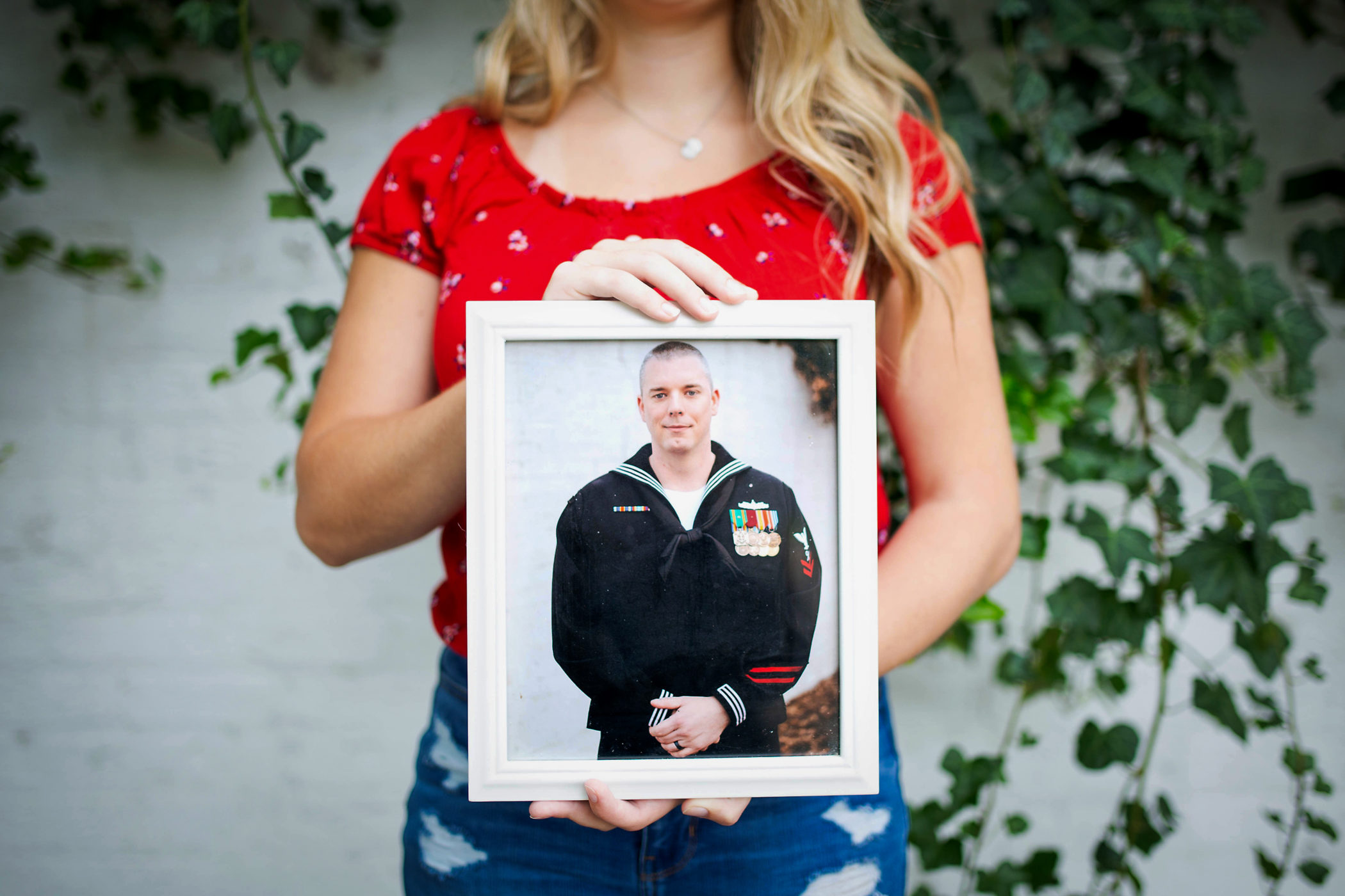 Audrey Schiesser holds a picture of her husband, Ryan Schiesser