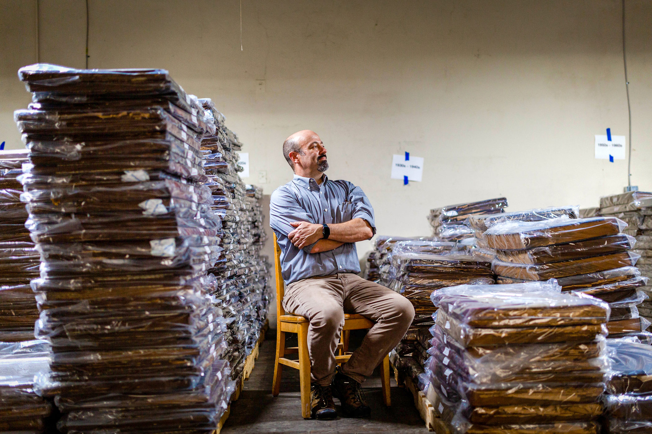 Andrew Feight sits among stacks of newspaper archives