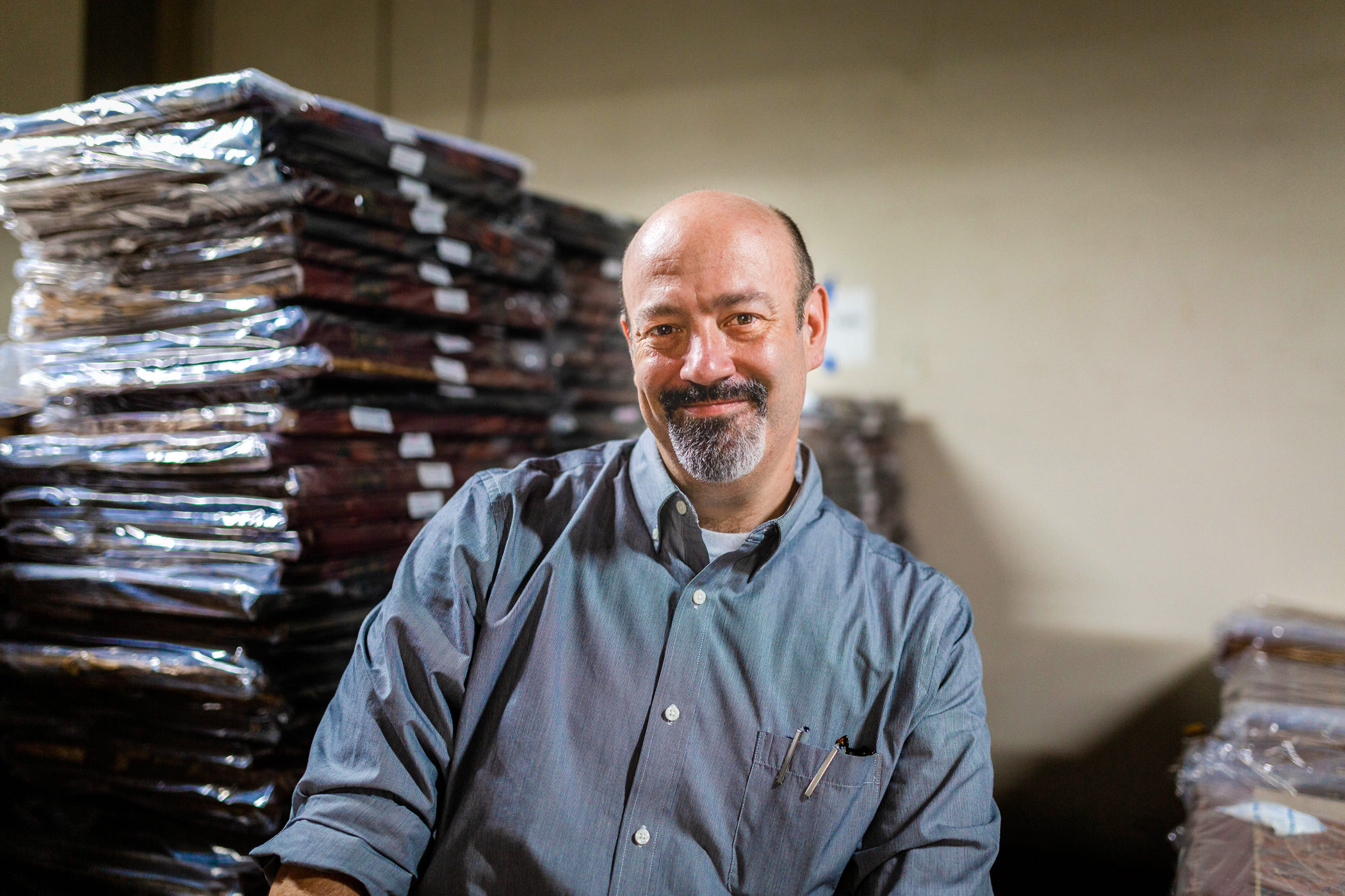 Andrew Feight sits among stacks of newspaper archives