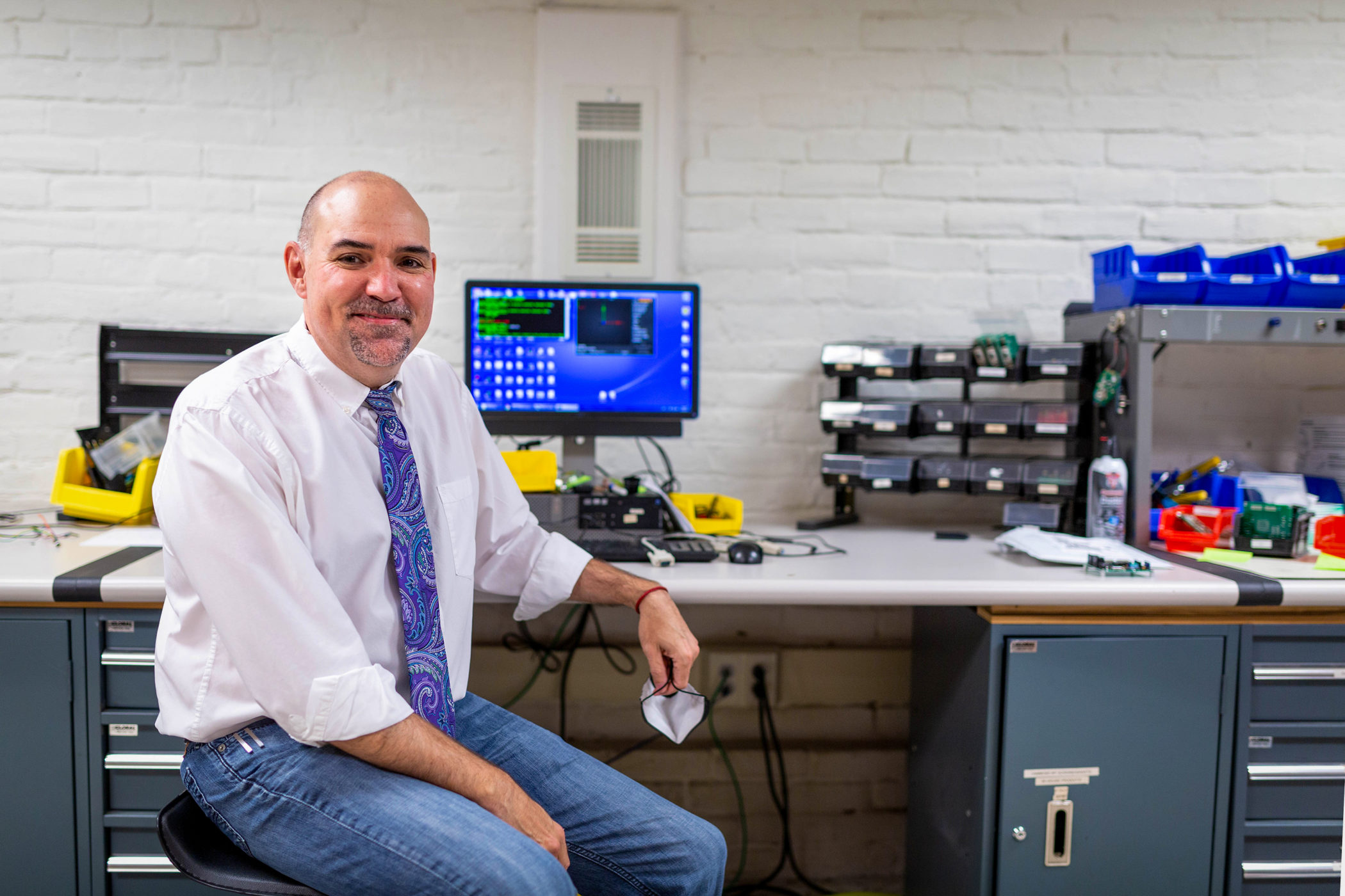 Paul Yost sitting at work station