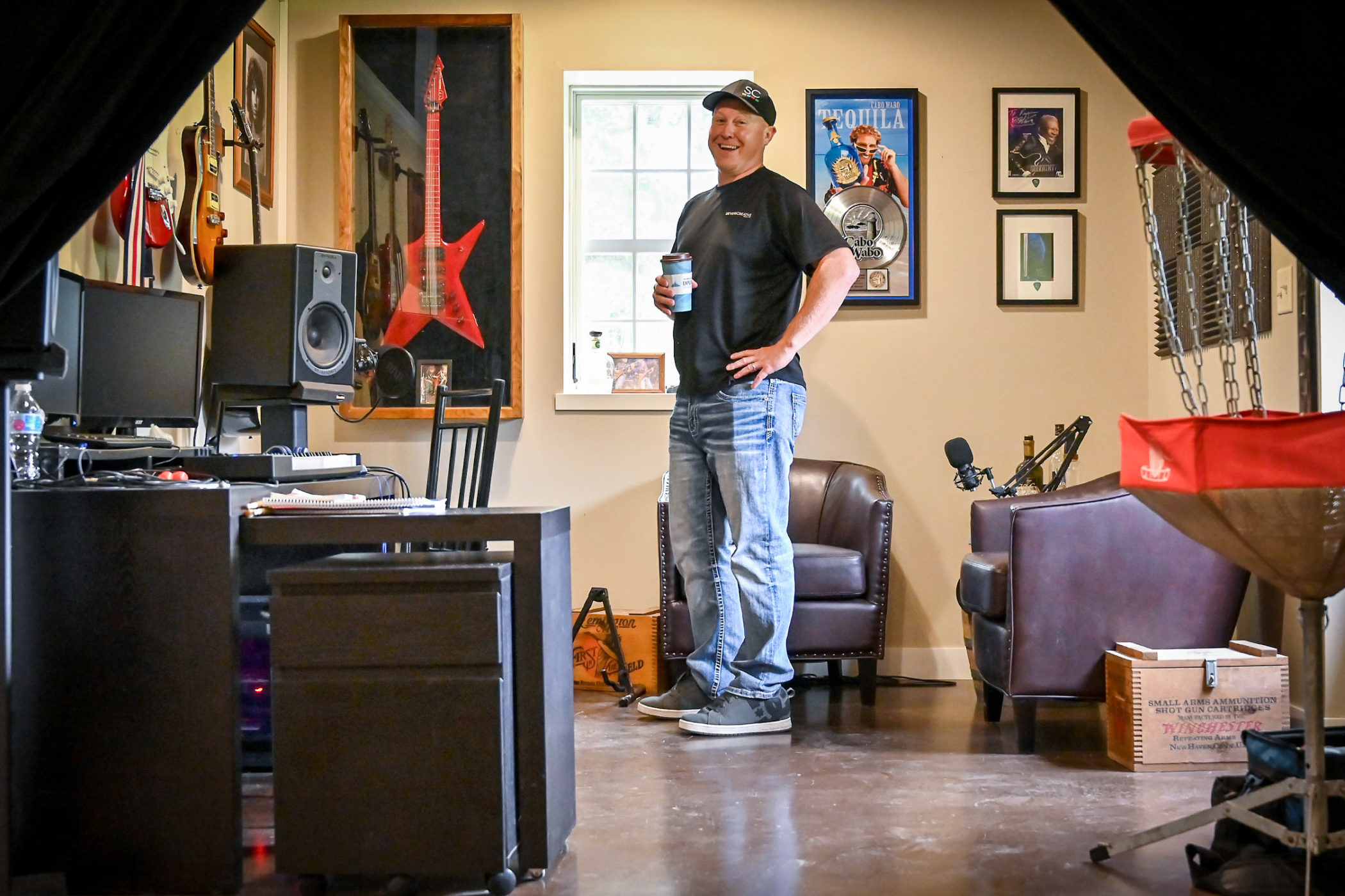 Roger Sievers laughs while talking about memorabilia in his office