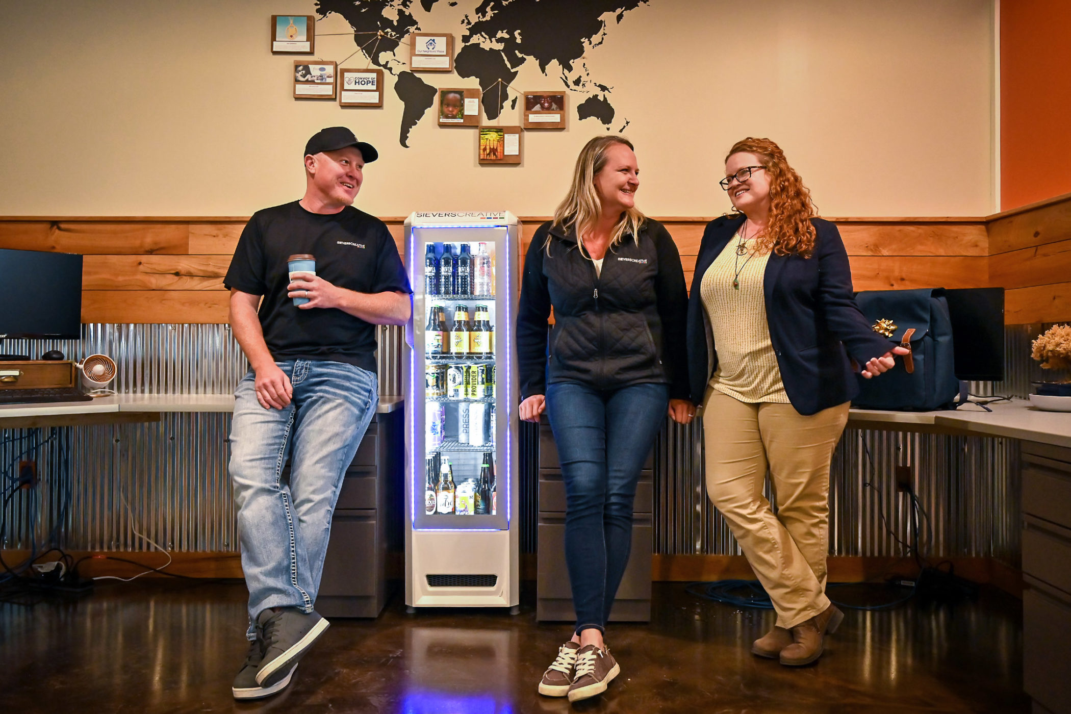 Roger, Renee, and Jessica Sievers chat in the Sievers Creative office
