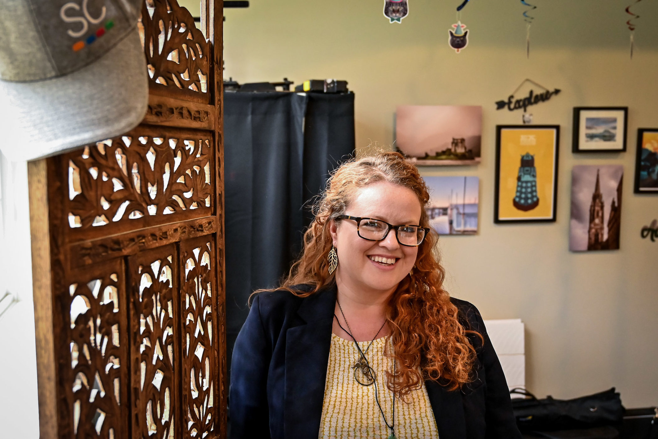 Jessica Sievers stands in front of a window shade