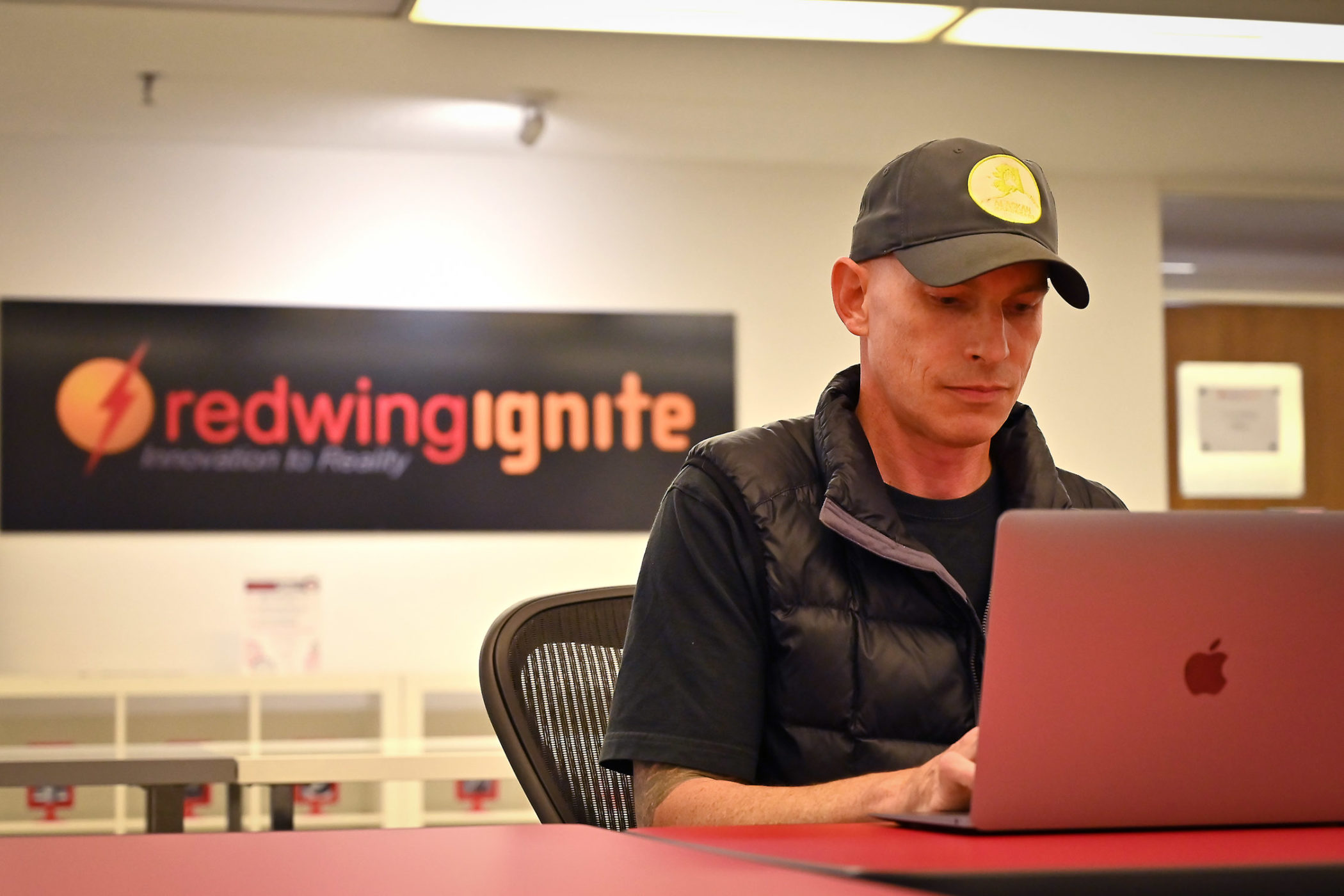 Eric Amundson works at his computer at Red Wing Ignite