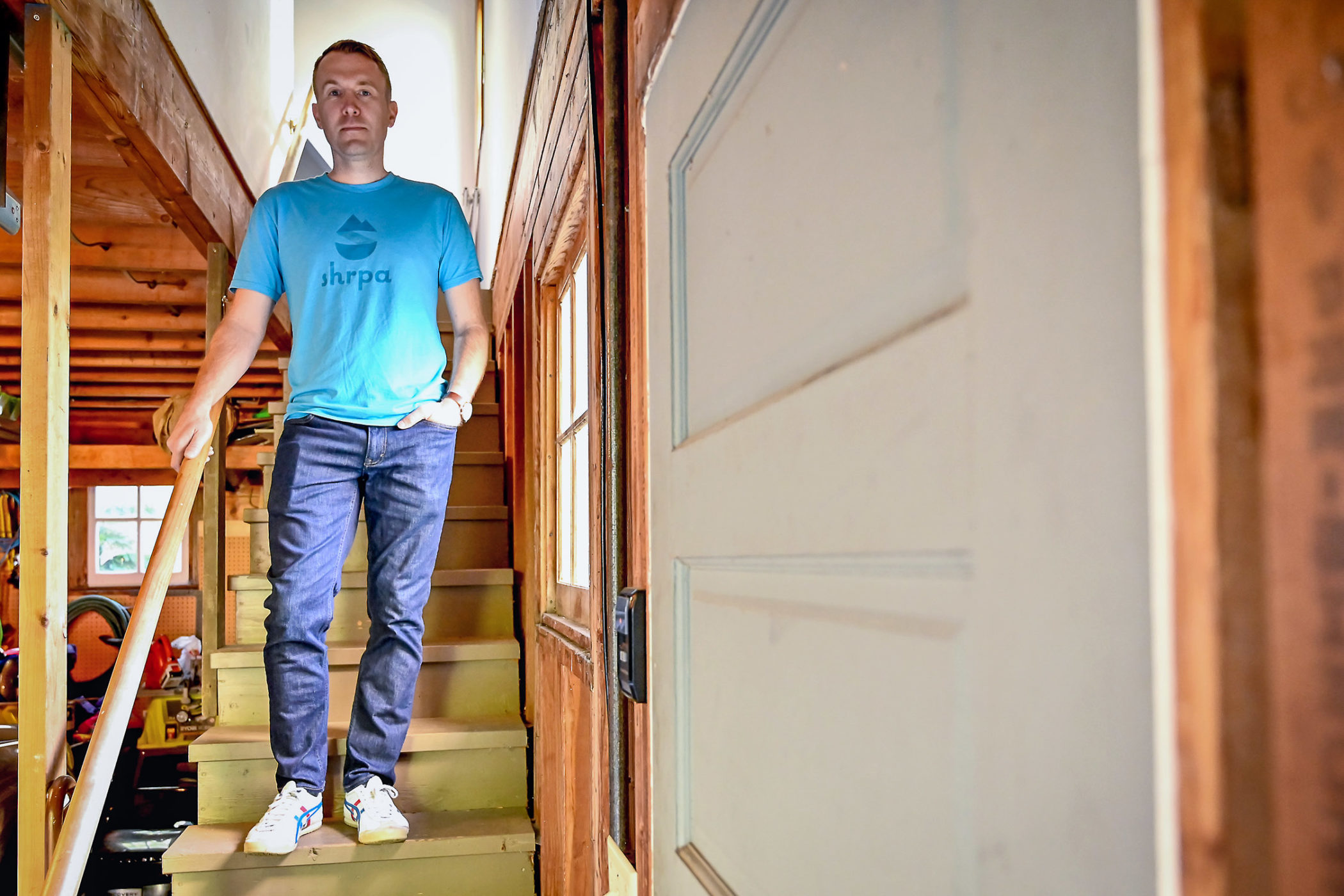 Andy Vig standing on the stairs to his office