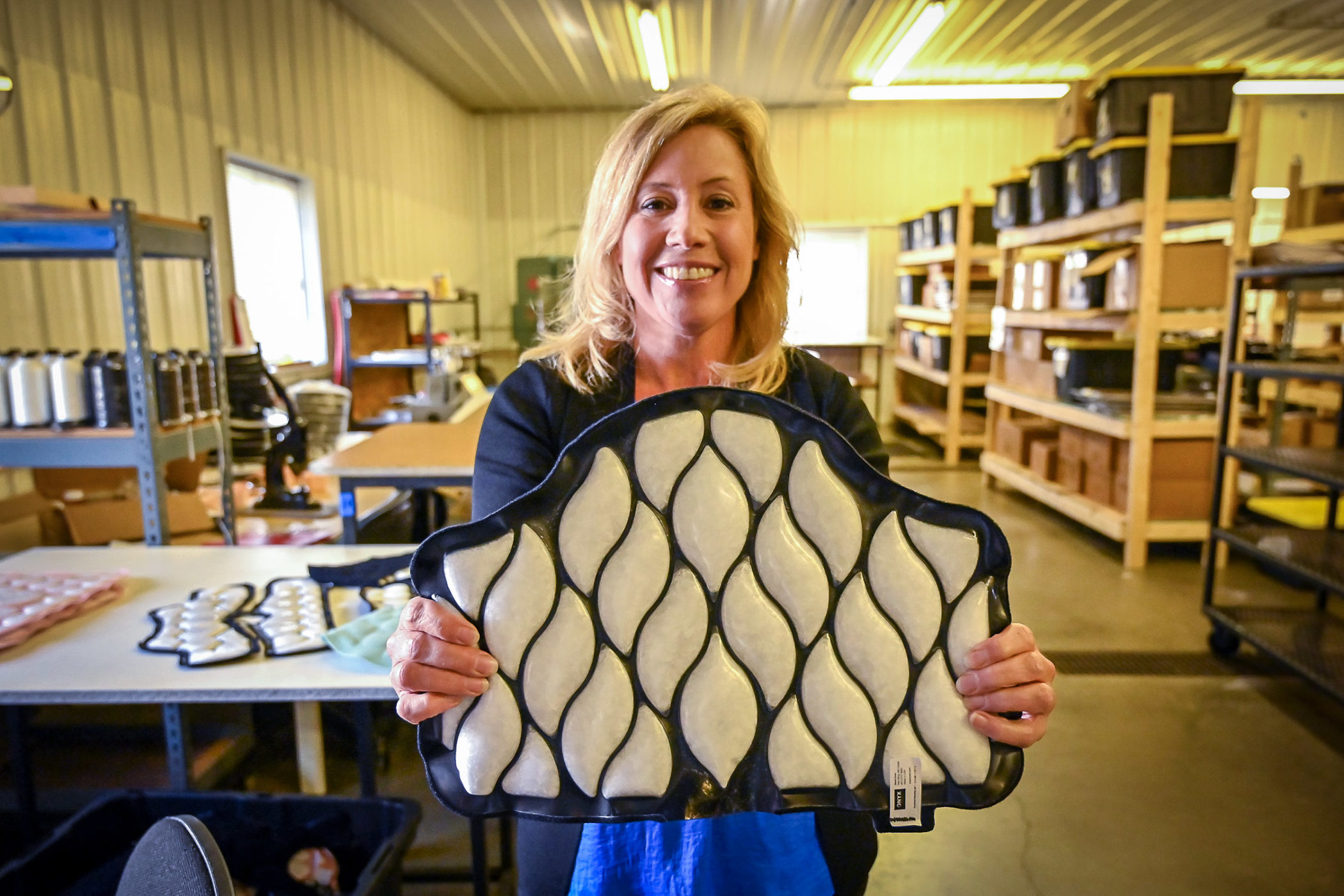 Tammy Lee holds up a product in the Xena Therapies facility in Red Wing, Minnesota