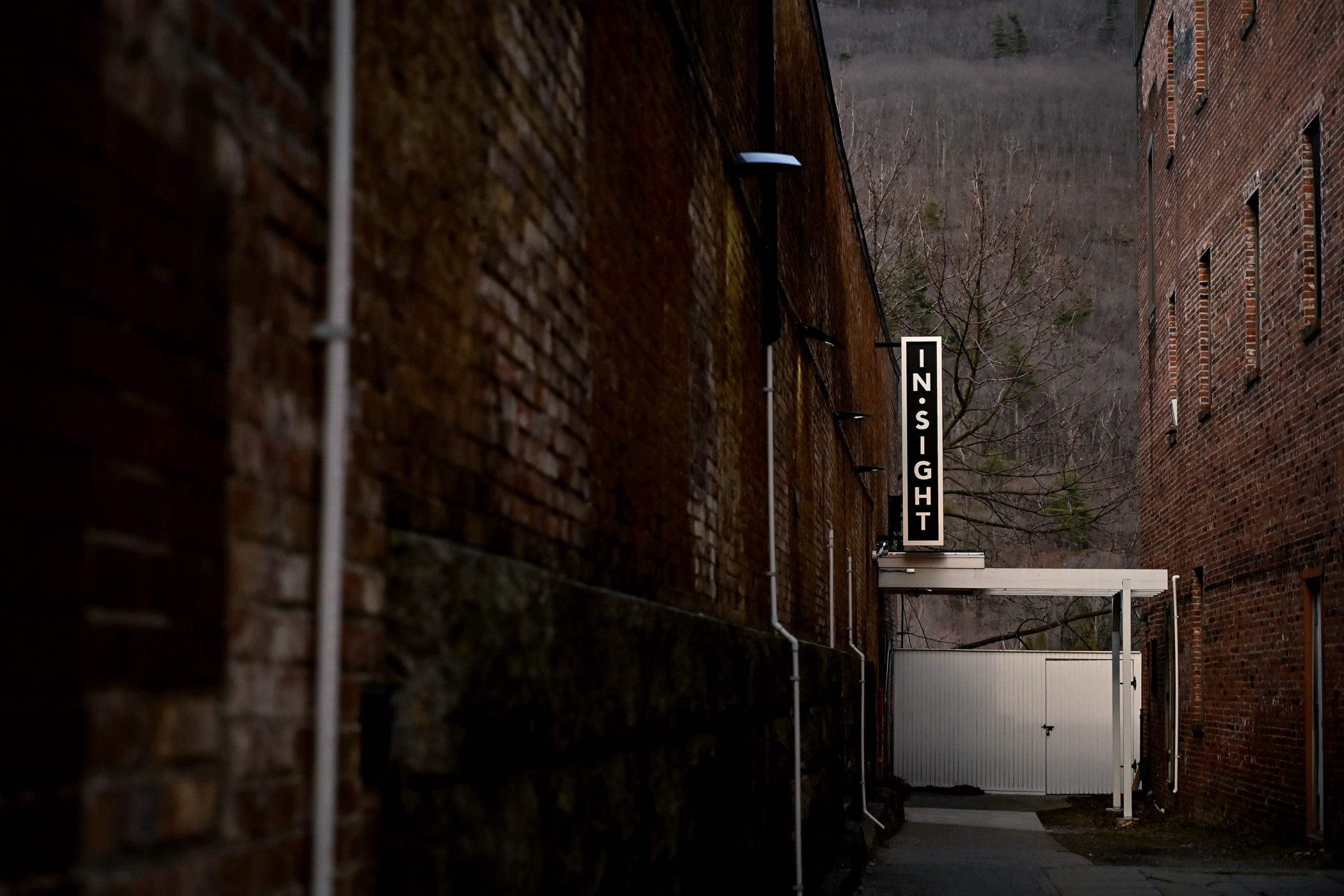 A sign down says "Insight" at the end of an alley in downtown Brattleboro, Vermont.