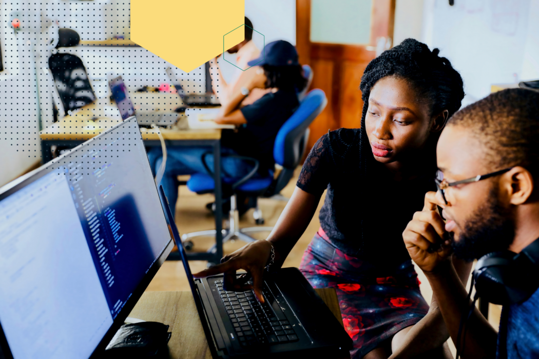 Learners enrolled in tech training course working at a computer.