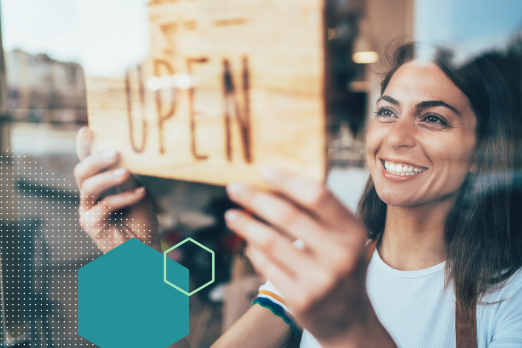 woman flipping sign to "OPEN"